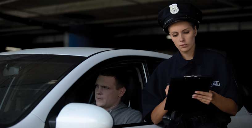 SLi - Female officer writing traffic ticket