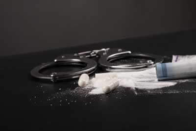 SLI - Arrest for drug dealing, handcuffs and white powder cocaine